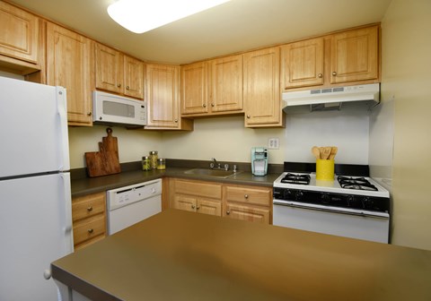 Bright kitchen with plenty of cabinets at Winston Apartments, Baltimore